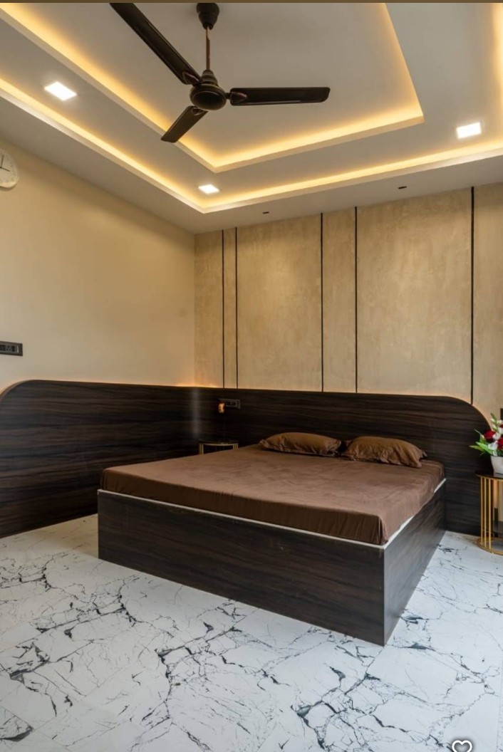 Bedroom with warm cove lighting and wooden bed